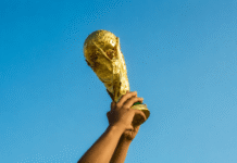 World Cup 2026 Betting Markets After the Opening Matches Hands raising a championship trophy against a clear blue sky