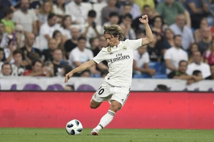 Luka Modrić controlling the ball in midfield, illustrating his passing, vision, tempo control and technical ability.
