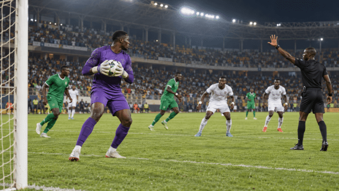 Referee signals the countdown as a goalkeeper holds the ball during a football match
