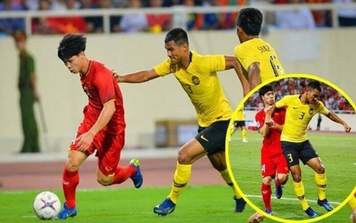 Football referee reviewing possible violent conduct between two players
