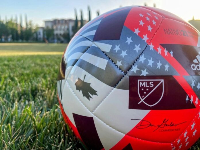 MLS football match showing a home team playing against visiting opponents in a packed stadium